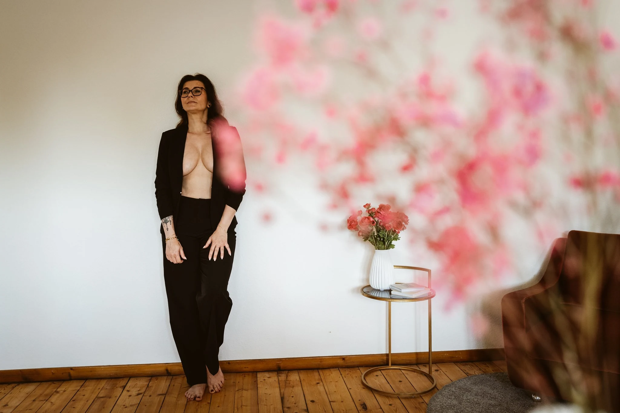 Julia im schwarzen Anzug, Blumen im Vordergrund